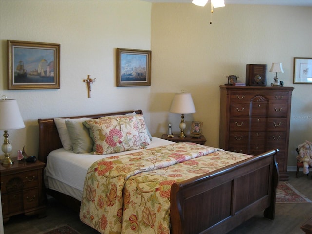 bedroom with dark hardwood / wood-style floors