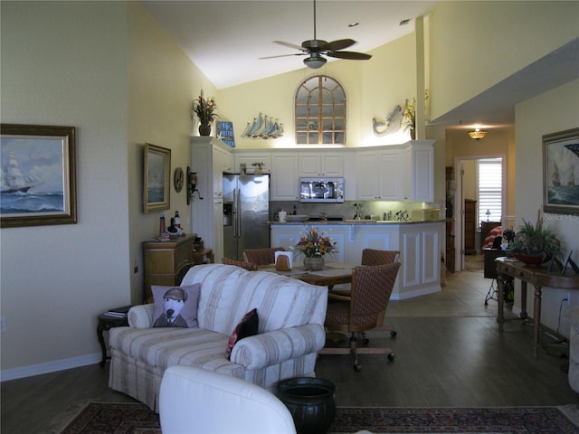 living room featuring dark hardwood / wood-style floors, high vaulted ceiling, and ceiling fan