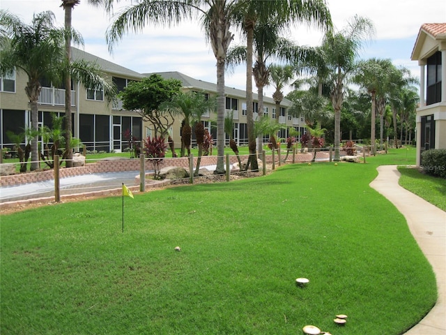 view of home's community with a yard