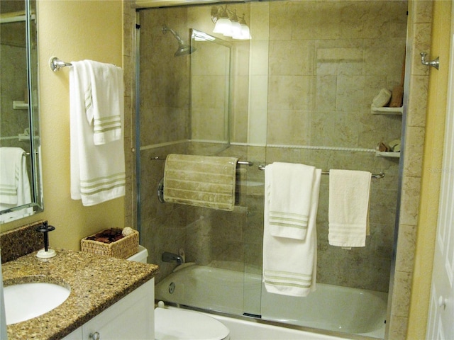 434 Bouchelle Dr Unit 304, New Smyrna Beach, FL 32169 - bathroom featuring bath / shower combo with glass door, vanity, and toilet