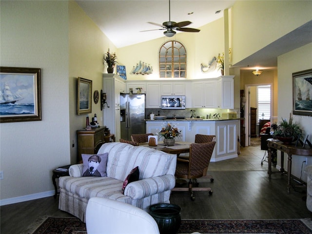 434 Bouchelle Dr Unit 304, New Smyrna Beach, FL 32169 - living room with high vaulted ceiling, a ceiling fan, wood finished floors, and baseboards