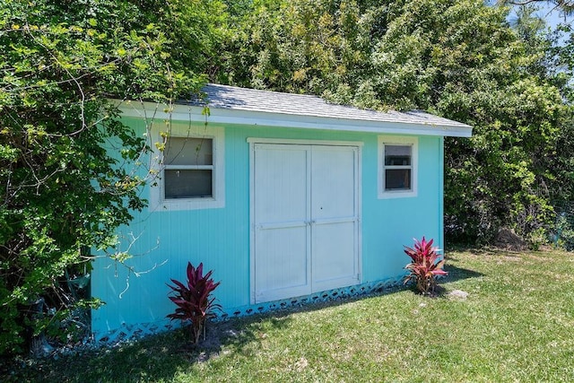 view of outbuilding featuring a lawn