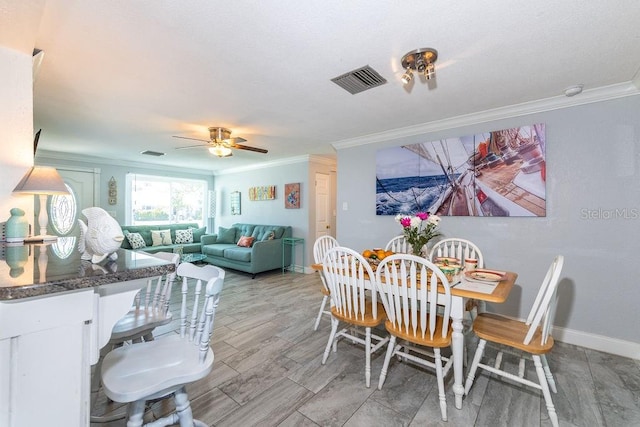 dining area with ceiling fan and ornamental molding