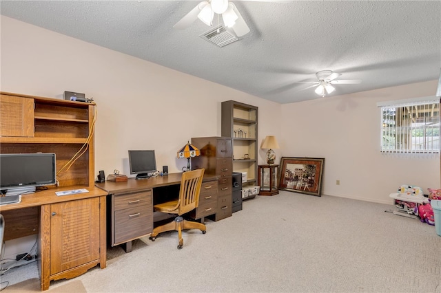 carpeted office featuring ceiling fan and a textured ceiling