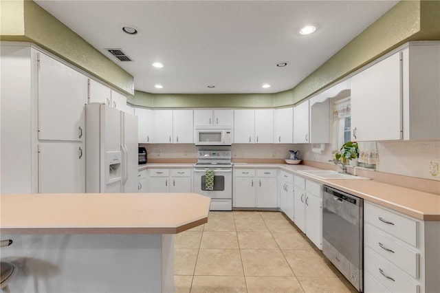 kitchen featuring white cabinetry, white appliances, and sink