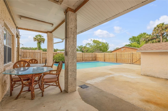 view of patio / terrace with a fenced in pool