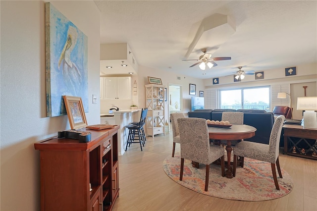 dining room featuring light wood-type flooring and ceiling fan