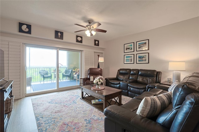 living room with ceiling fan and wood-type flooring