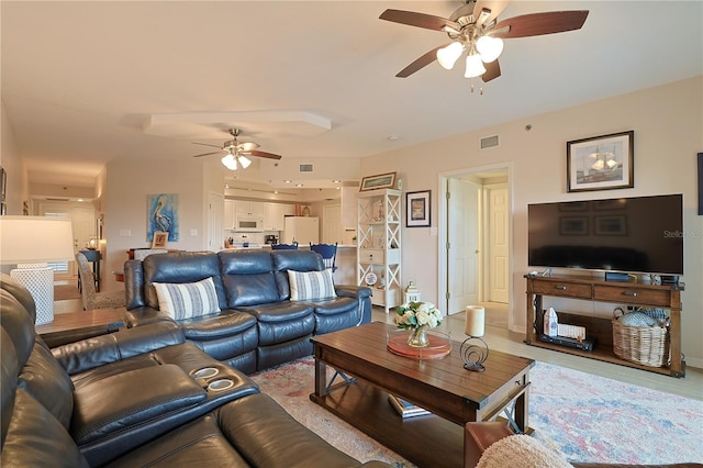 living room with light hardwood / wood-style flooring and ceiling fan