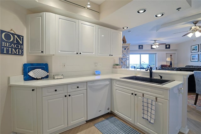 kitchen with dishwasher, decorative backsplash, white cabinetry, and sink