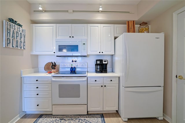 kitchen with decorative backsplash, white cabinets, light hardwood / wood-style floors, and white appliances