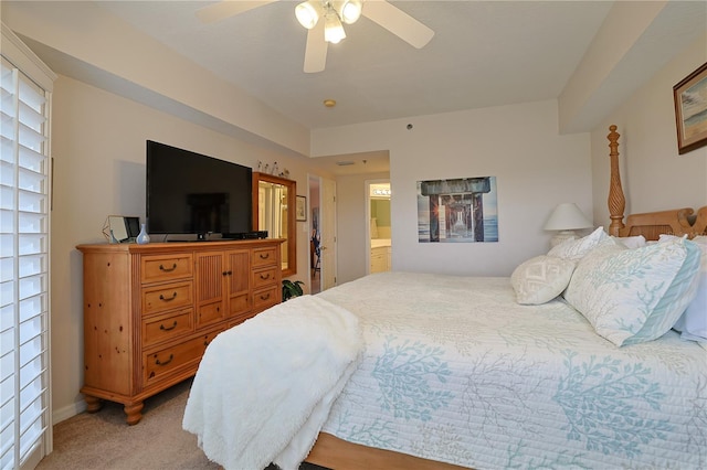 bedroom featuring connected bathroom, ceiling fan, and light carpet