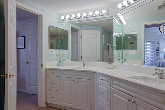 bathroom featuring a textured ceiling and vanity