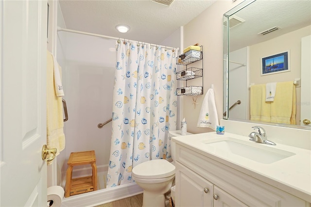 bathroom featuring vanity, a textured ceiling, hardwood / wood-style floors, toilet, and curtained shower