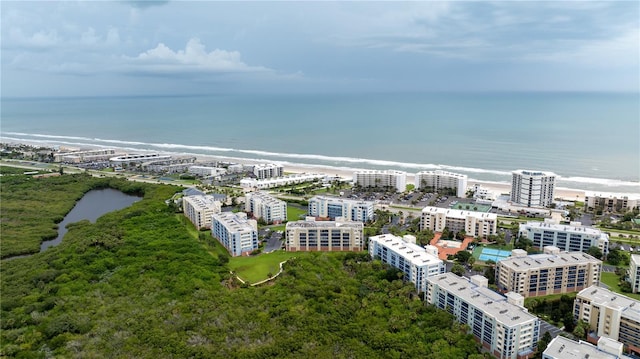 bird's eye view with a water view and a beach view