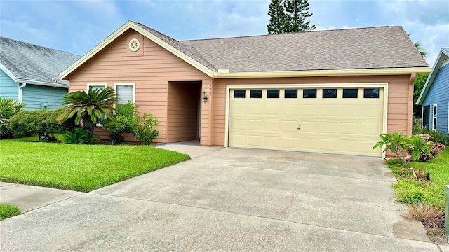 view of front of house featuring a front lawn and a garage