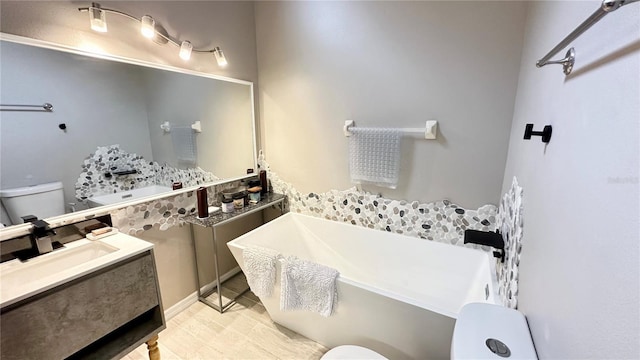 bathroom featuring tile patterned flooring, vanity, and toilet