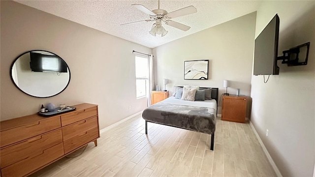 bedroom featuring light wood-type flooring, a textured ceiling, ceiling fan, and lofted ceiling