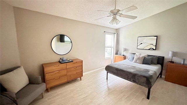 bedroom featuring ceiling fan and a textured ceiling