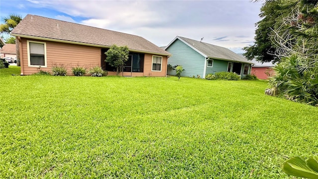 back of property with a lawn