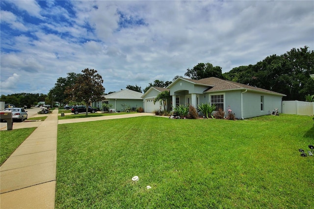 ranch-style home with a garage and a front lawn