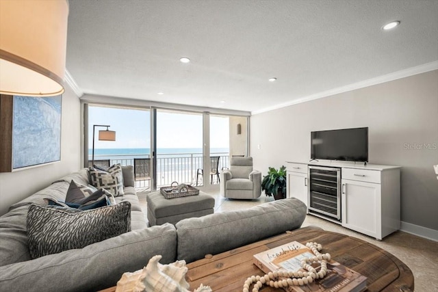 living room with a wall of windows, crown molding, and beverage cooler