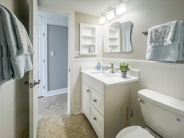 bathroom featuring tile patterned floors, vanity, and toilet