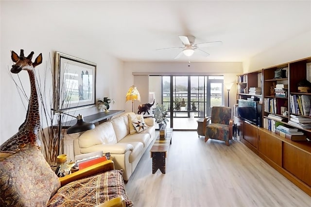 living room featuring ceiling fan and light wood-type flooring