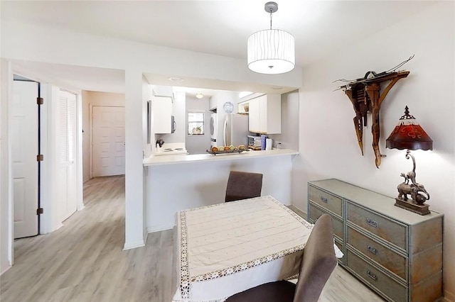 dining area featuring light wood-type flooring