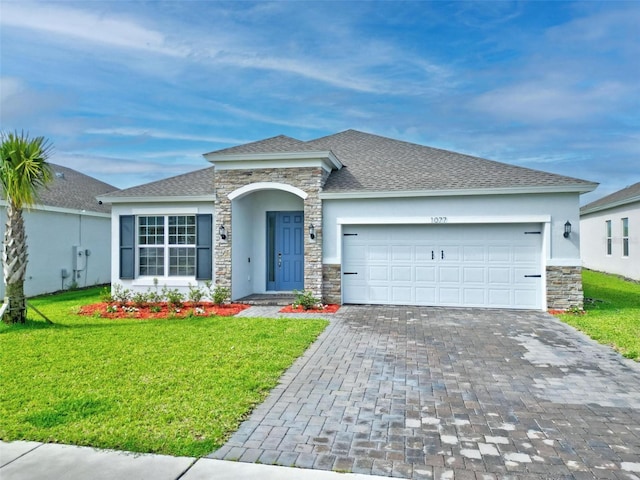 ranch-style house featuring a garage and a front lawn