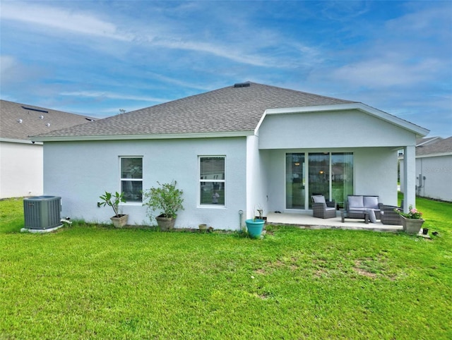 rear view of house featuring a lawn, a patio area, and central air condition unit