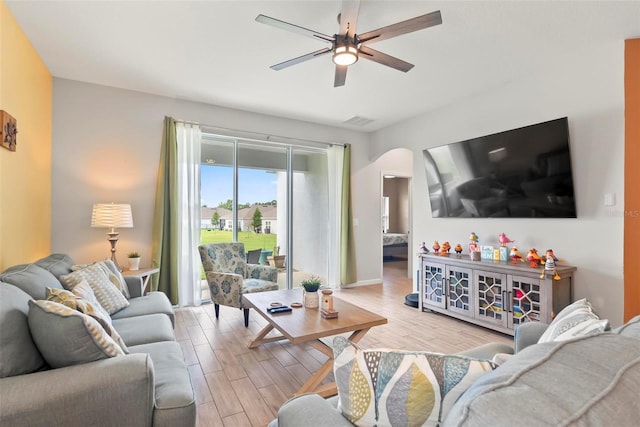 living room featuring ceiling fan and light hardwood / wood-style floors