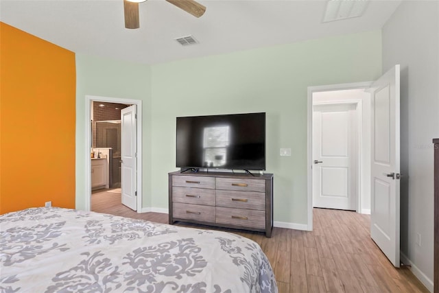 bedroom with connected bathroom, ceiling fan, and light hardwood / wood-style floors