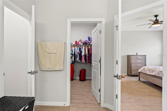 bedroom featuring light hardwood / wood-style flooring, a closet, and ceiling fan