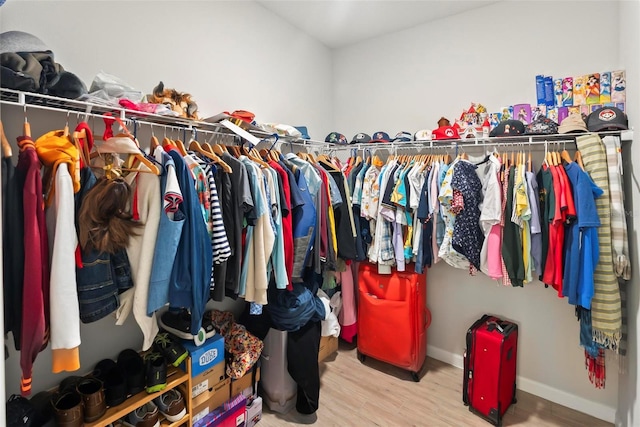 walk in closet featuring light hardwood / wood-style flooring