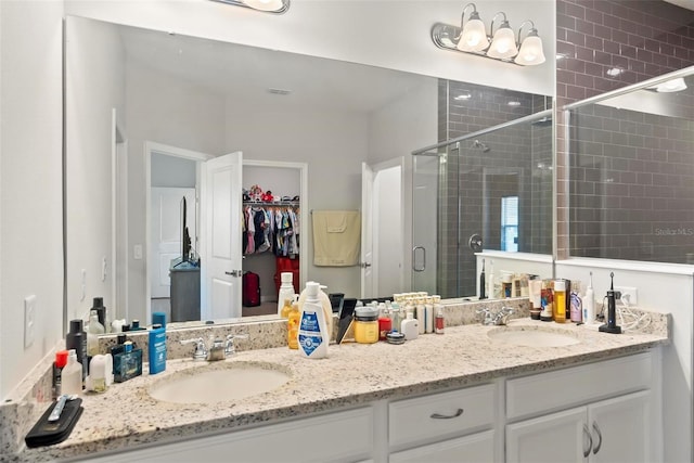 bathroom with vanity and a shower with door