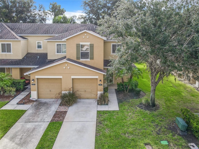 view of front of property with a garage and a front lawn