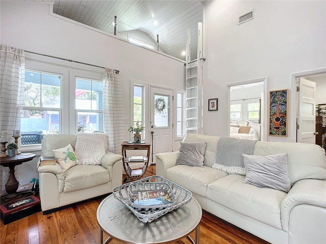 living room featuring dark hardwood / wood-style flooring, wooden ceiling, and high vaulted ceiling