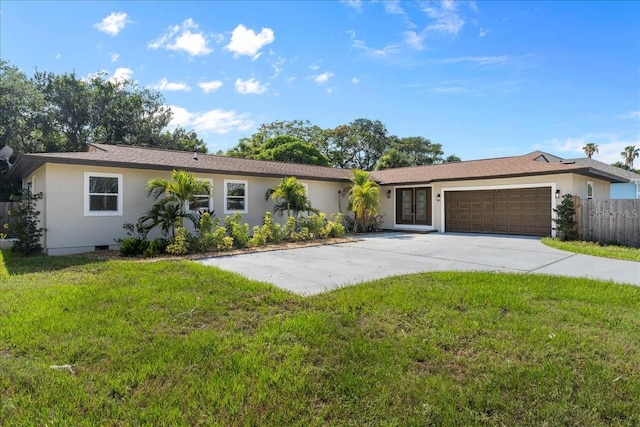 ranch-style house with french doors, a garage, and a front lawn