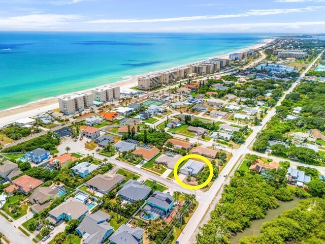 drone / aerial view with a beach view and a water view