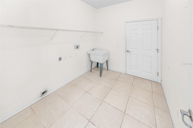 washroom with light tile patterned flooring, hookup for a washing machine, hookup for an electric dryer, laundry area, and baseboards