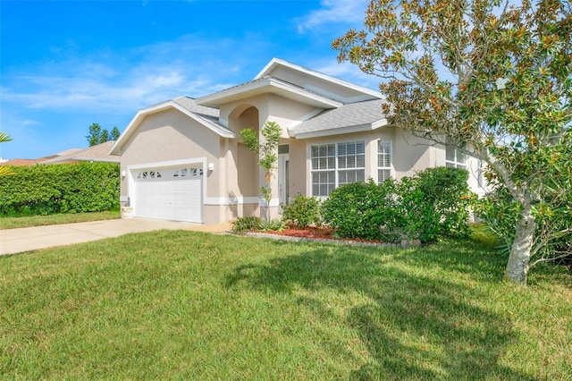 ranch-style home featuring a front lawn, concrete driveway, an attached garage, and stucco siding