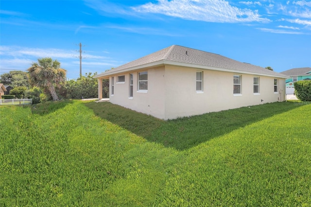 view of property exterior featuring a lawn and stucco siding