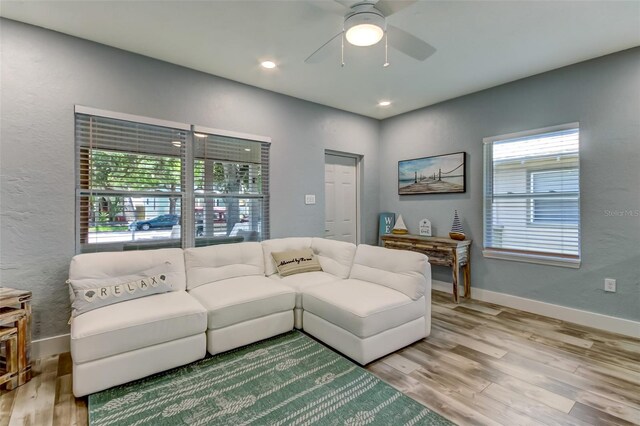 living room featuring hardwood / wood-style floors and ceiling fan