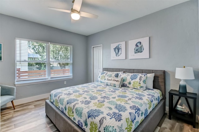 bedroom featuring wood-type flooring, a closet, and ceiling fan