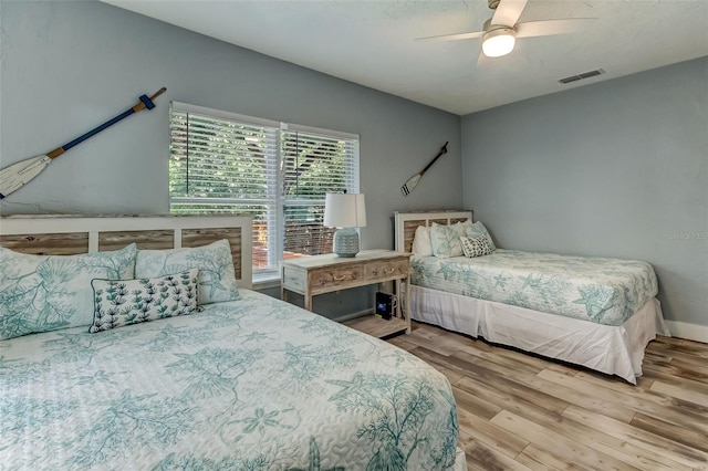 bedroom with hardwood / wood-style flooring and ceiling fan