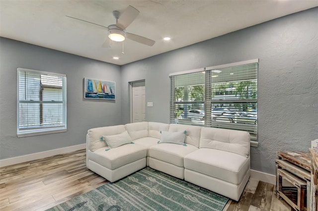 living room with hardwood / wood-style floors and ceiling fan