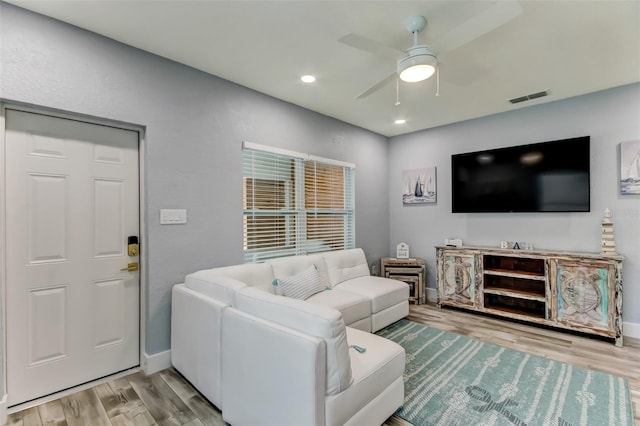 living room with ceiling fan and light hardwood / wood-style floors