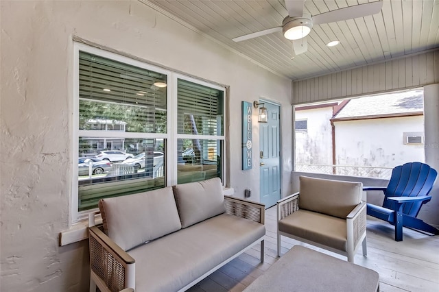 sunroom / solarium featuring ceiling fan and a wealth of natural light