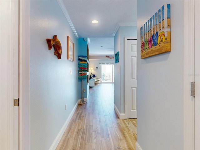 hall featuring light wood-type flooring and crown molding